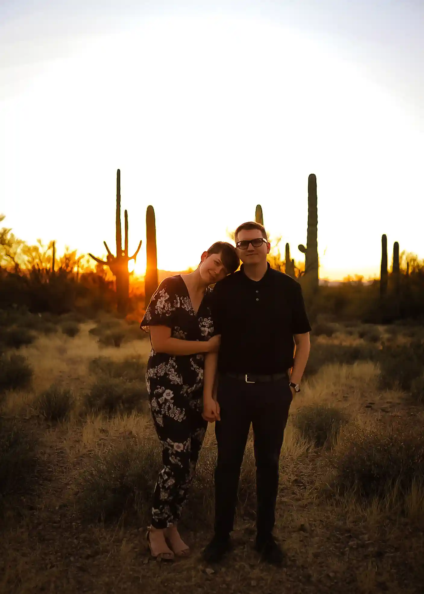 Shelley and Ted stand side by side at sunset. Their arms are interlinked